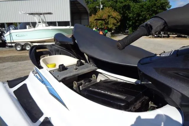 Slide: The Image of 2004 Yamaha WaveRunner FX Cruiser with open seat, showing internal components, parked near other boats. - 7