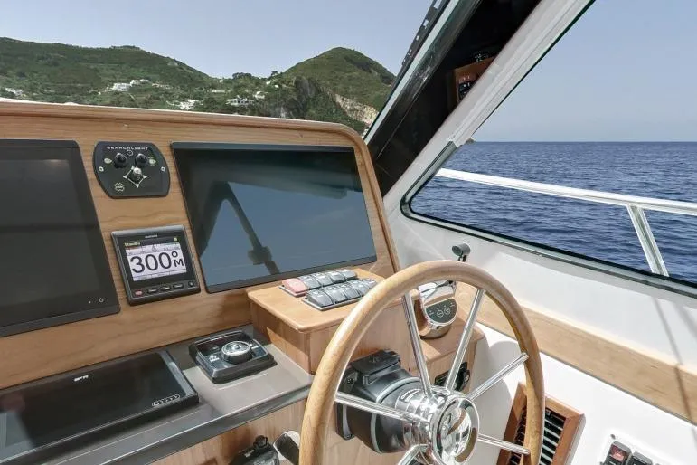 Slide: The Image of Helm of 2026 Back Cove 372 yacht with ocean view and navigation screens. - 3