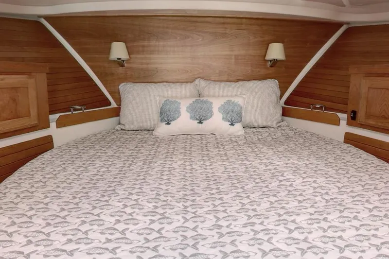 Slide: The Image of Cozy cabin bedroom in 2026 Back Cove 372 yacht with nautical-themed bedding. - 5