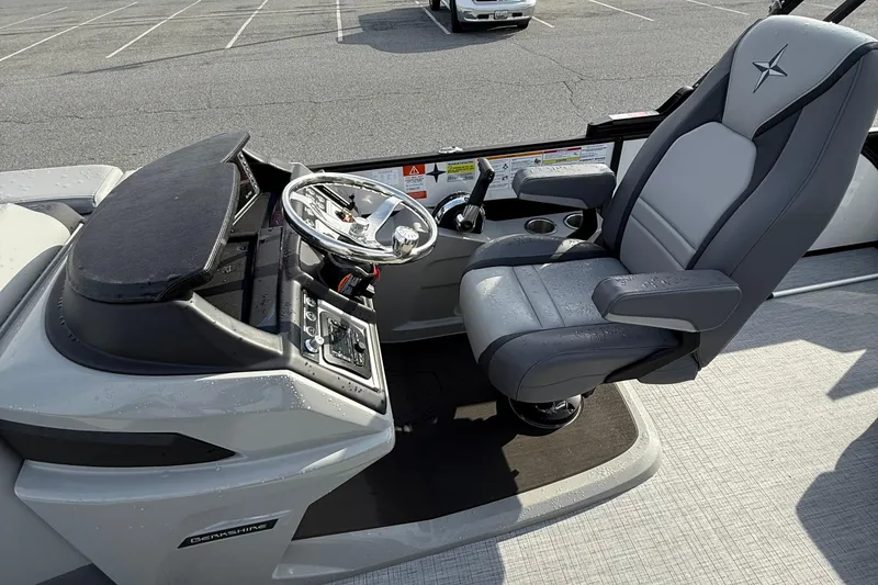 Slide: The Image of 2026 Berkshire 23CL STS boat cockpit with steering wheel and captain's chair. - 10