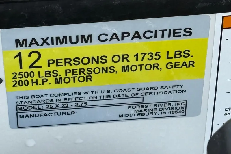 Slide: The Image of 2026 Berkshire 23CL STS boat capacity label: 12 persons, 1735 lbs, 200 HP motor. - 14