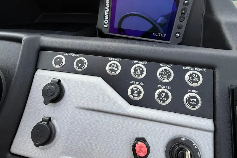 Slide: The Image of 2026 Berkshire 23CL STS pontoon boat with black canopy and motor, parked outdoors. - 5