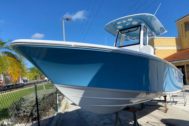 The Image of 2026 Sportsman Masters 227 Bay Boat in vibrant blue, displayed outdoors under clear skies. - 0
