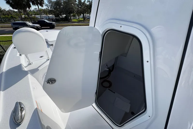 Slide: The Image of 2026 Sportsman Masters 227 Bay Boat with open storage compartment on deck. - 12