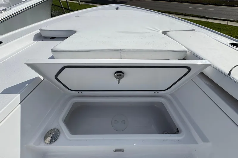 Slide: The Image of 2026 Sportsman Masters 227 Bay Boat with open storage compartment on deck. - 15