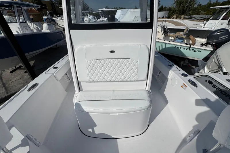 Slide: The Image of 2026 Sportsman Masters 227 Bay Boat interior with white seating and console. - 16