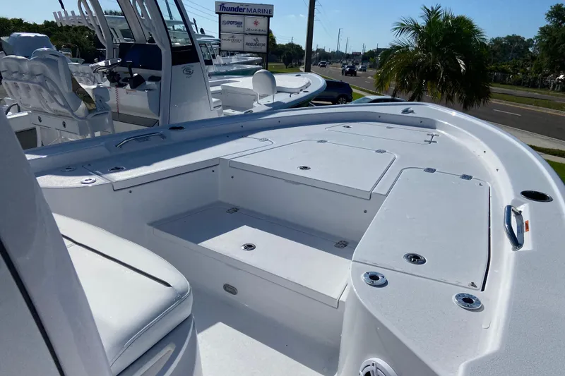 Slide: The Image of 2026 Sportsman Masters 227 Bay Boat with spacious deck and seating, displayed outdoors. - 18