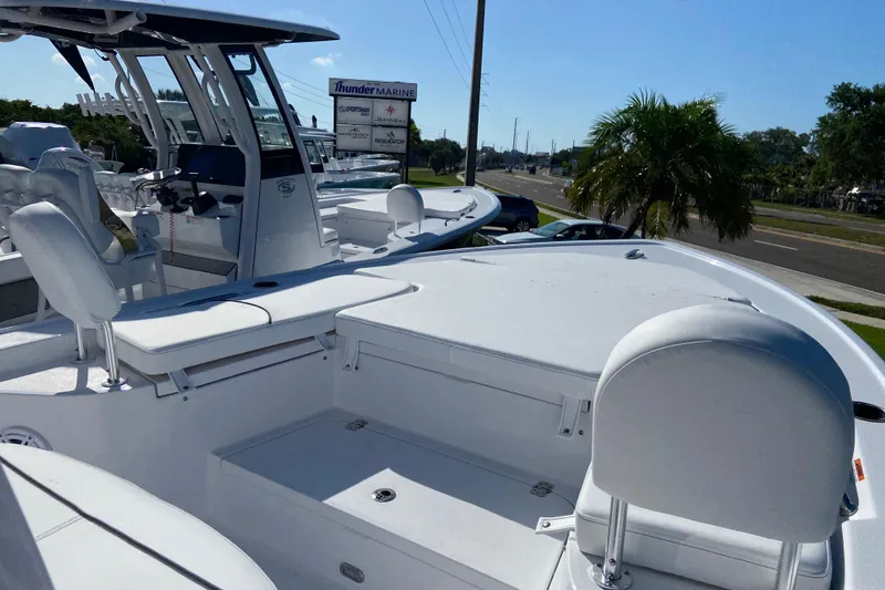 Slide: The Image of 2026 Sportsman Masters 227 Bay Boat docked, showcasing sleek design and spacious seating. - 21