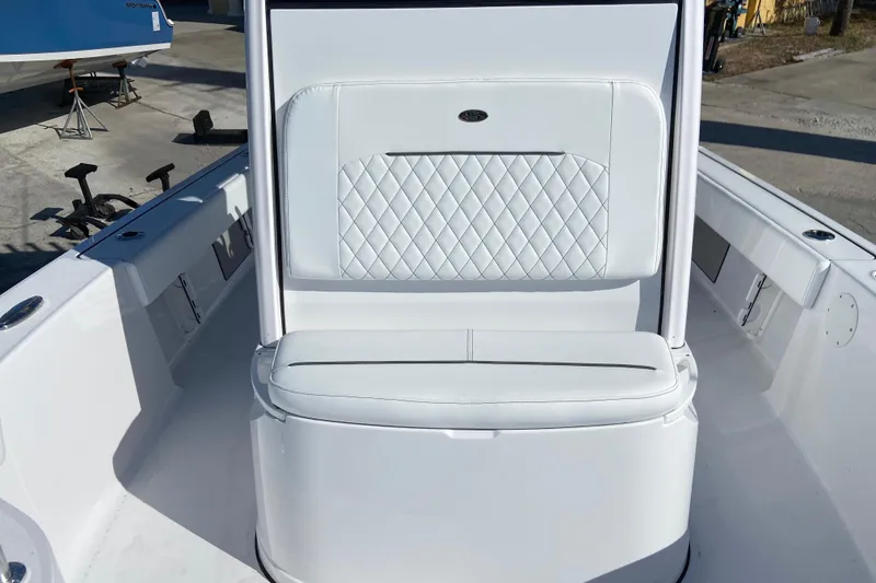 Slide: The Image of 2026 Sportsman Masters 227 Bay Boat interior with white cushioned seating and sleek design. - 22