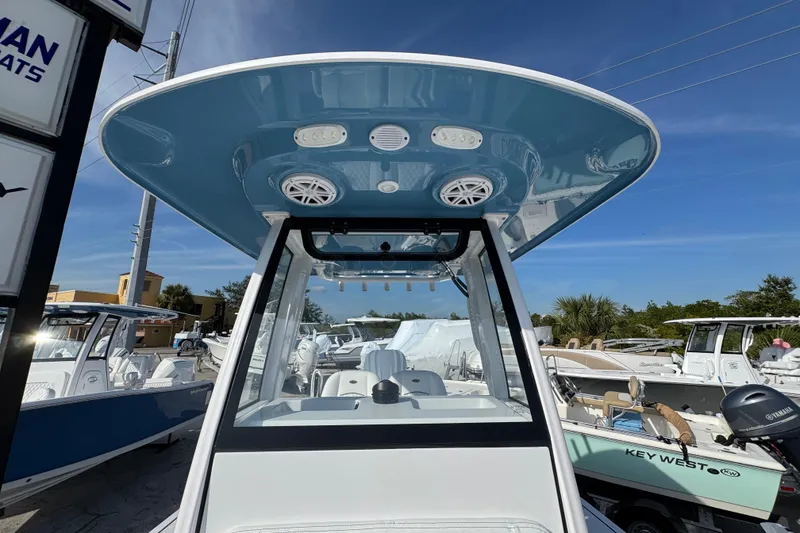 Slide: The Image of 2026 Sportsman Masters 227 Bay Boat with blue T-top and modern design. - 23