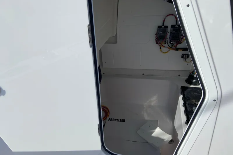 Slide: The Image of Open compartment of 2026 Sportsman Masters 227 Bay Boat showing wiring and components. - 25