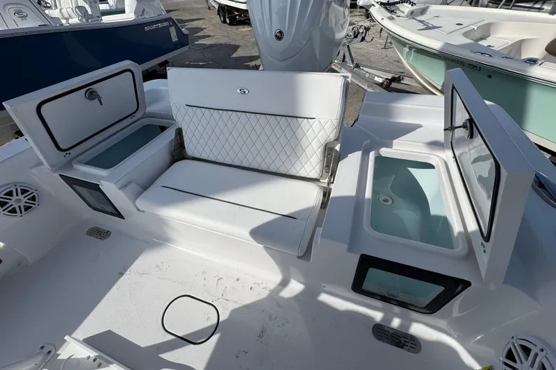 Slide: The Image of 2026 Sportsman Masters 227 Bay Boat interior with seating and storage compartments. - 6