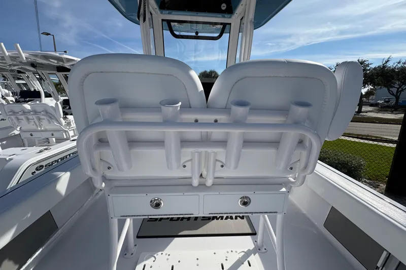 Slide: The Image of 2026 Sportsman Masters 227 Bay Boat interior with rod holders and seating. - 8
