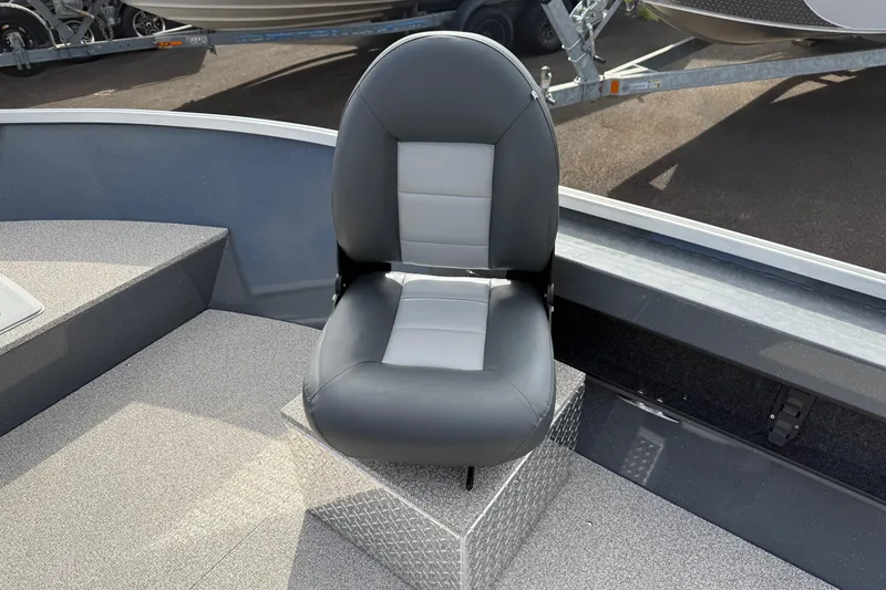 Slide: The Image of 2026 Fish Rite Angler 18 boat seat, gray and black design, on deck. - 12
