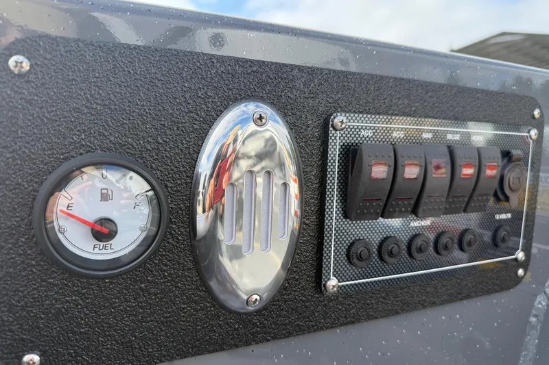 Slide: The Image of Control panel of 2026 Fish Rite Angler 18 boat with fuel gauge and switches. - 16
