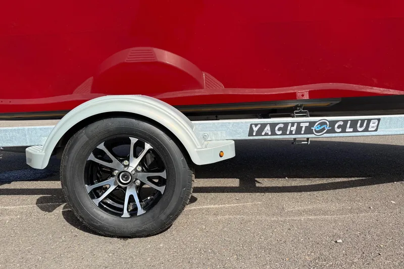 Slide: The Image of Trailer with black wheel and "Yacht Club" logo, Fish Rite Angler 18, 2026 model. - 20