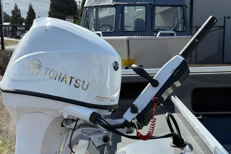 Slide: The Image of 2026 Fish Rite Angler 18 with Tohatsu outboard motor, close-up view. - 25