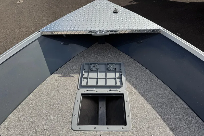 Slide: The Image of 2026 Fish Rite Angler 18 boat deck with storage compartments and diamond plate bow. - 6