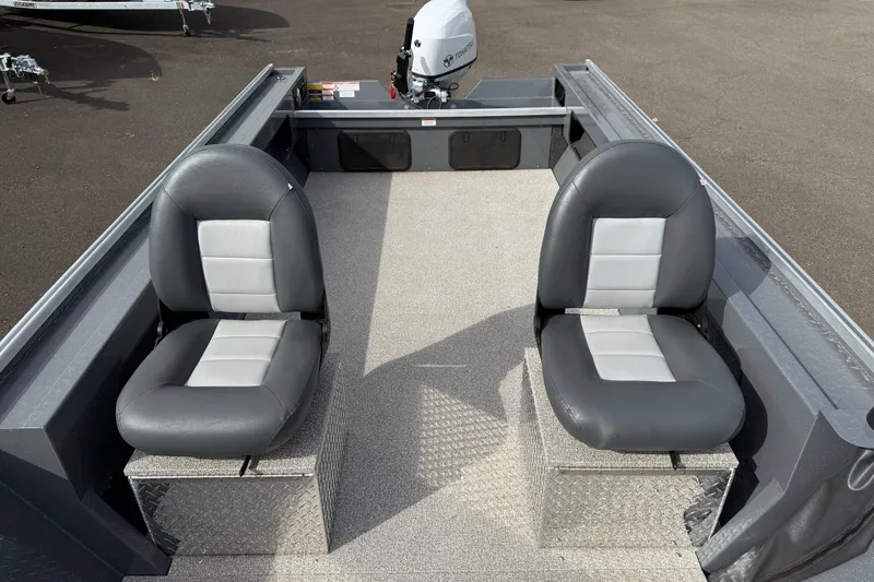 Slide: The Image of 2026 Fish Rite Angler 18 boat interior with two gray seats and a Tohatsu outboard motor. - 8