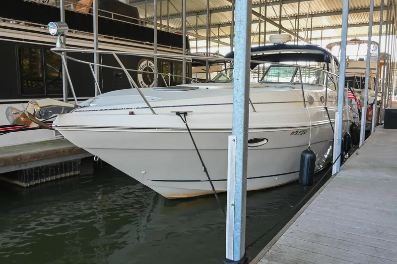 The Image of 2000 Rinker Fiesta Vee 330 boat docked in a marina. - 1
