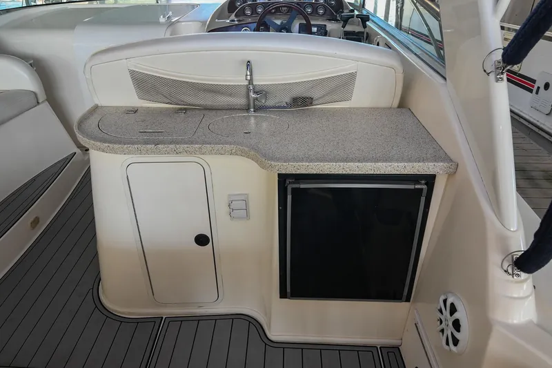 Slide: The Image of 2000 Rinker Fiesta Vee 330 boat interior with kitchenette and sink. - 10