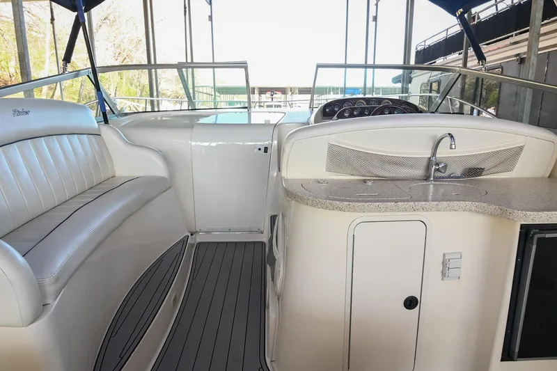 Slide: The Image of 2000 Rinker Fiesta Vee 330 boat interior with seating and kitchenette. - 11