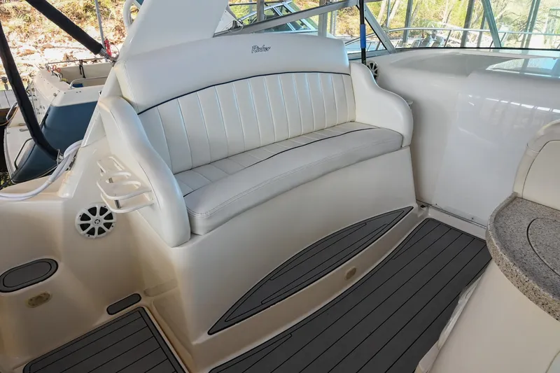 Slide: The Image of 2000 Rinker Fiesta Vee 330 boat interior with white seating and gray flooring. - 12