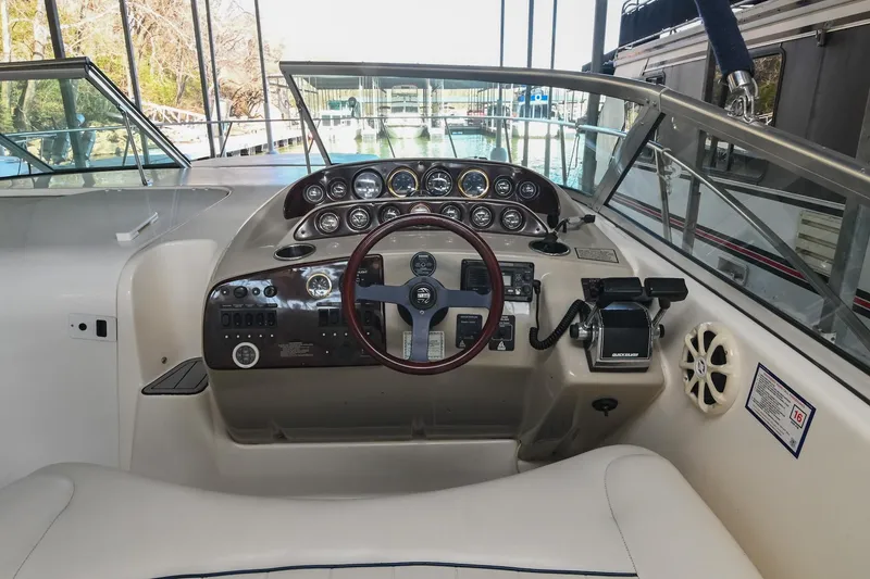 Slide: The Image of 2000 Rinker Fiesta Vee 330 boat cockpit with steering wheel and control panel. - 16