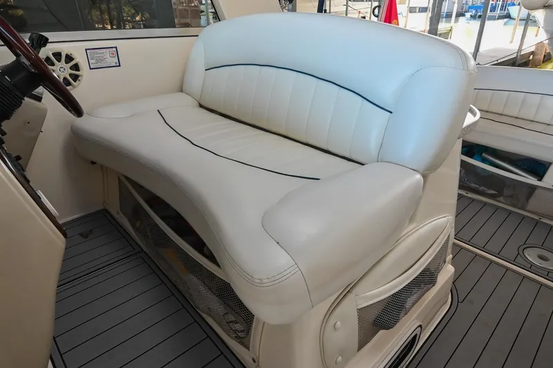 Slide: The Image of 2000 Rinker Fiesta Vee 330 boat interior with white leather seating. - 20