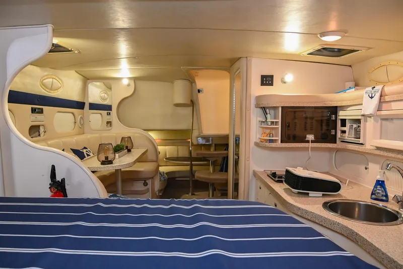 Slide: The Image of Interior of 2000 Rinker Fiesta Vee 330 yacht with cozy seating and kitchenette. - 23