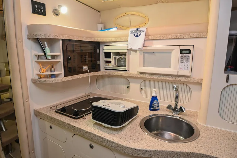 Slide: The Image of Interior of 2000 Rinker Fiesta Vee 330 yacht kitchen with modern amenities. - 29