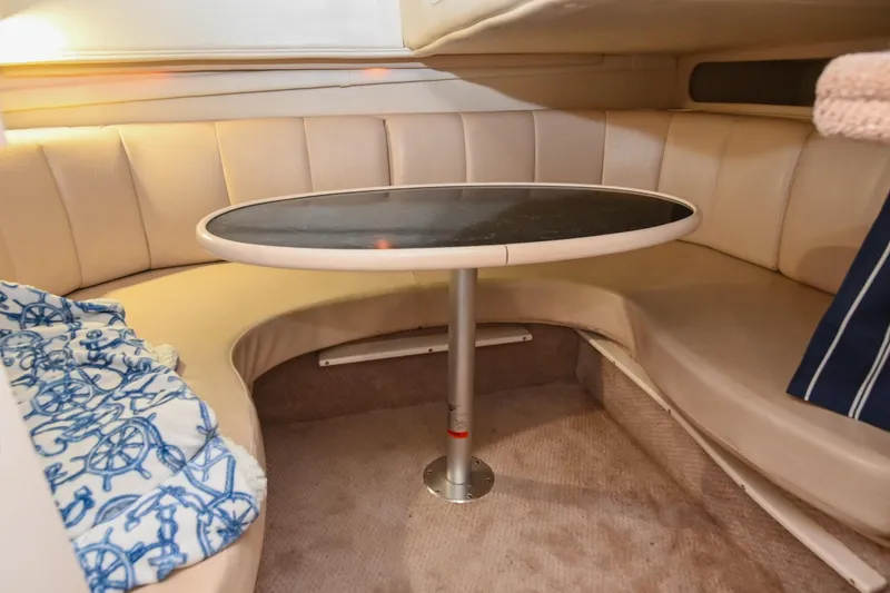 Slide: The Image of 2000 Rinker Fiesta Vee 330 interior with curved seating and oval table. - 36