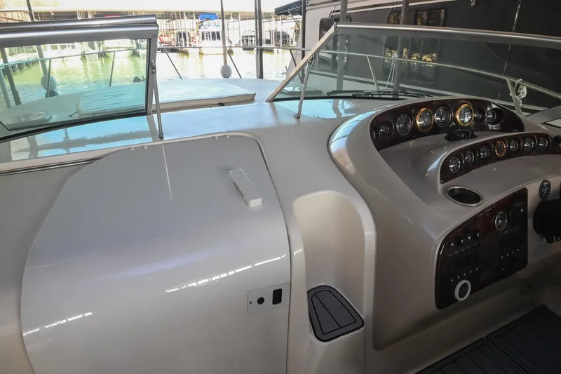 Slide: The Image of 2000 Rinker Fiesta Vee 330 boat dashboard with gauges and controls. - 41