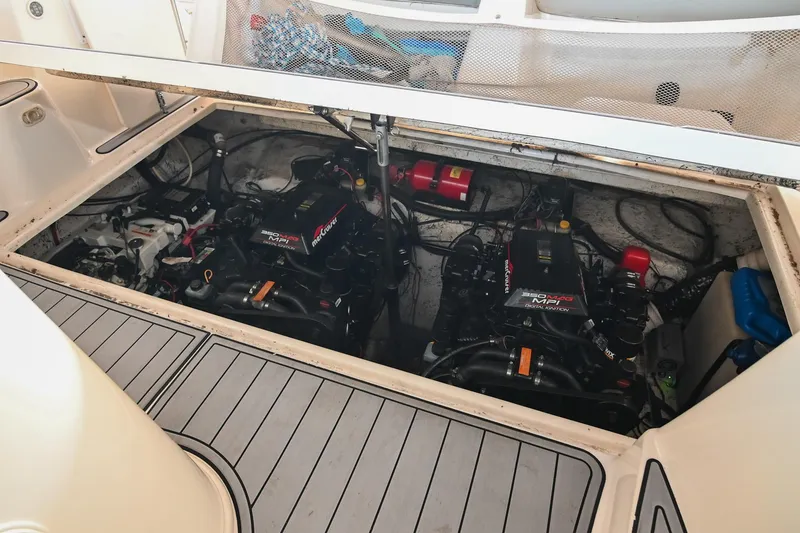Slide: The Image of Engine compartment of 2000 Rinker Fiesta Vee 330 boat, showcasing dual engines. - 45