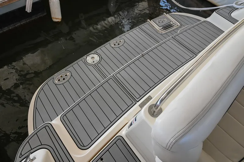 Slide: The Image of Rinker Fiesta Vee 330 2000 boat swim platform with gray decking and seating. - 6