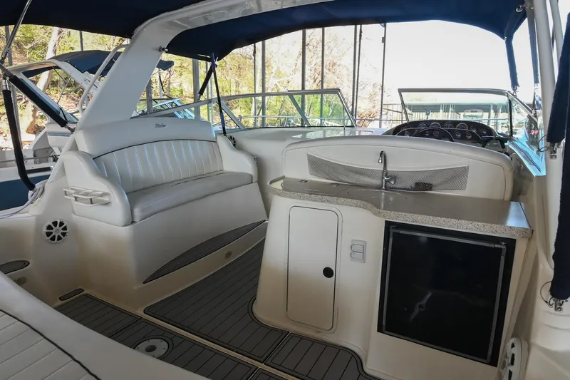 Slide: The Image of 2000 Rinker Fiesta Vee 330 boat interior with seating and kitchenette. - 7
