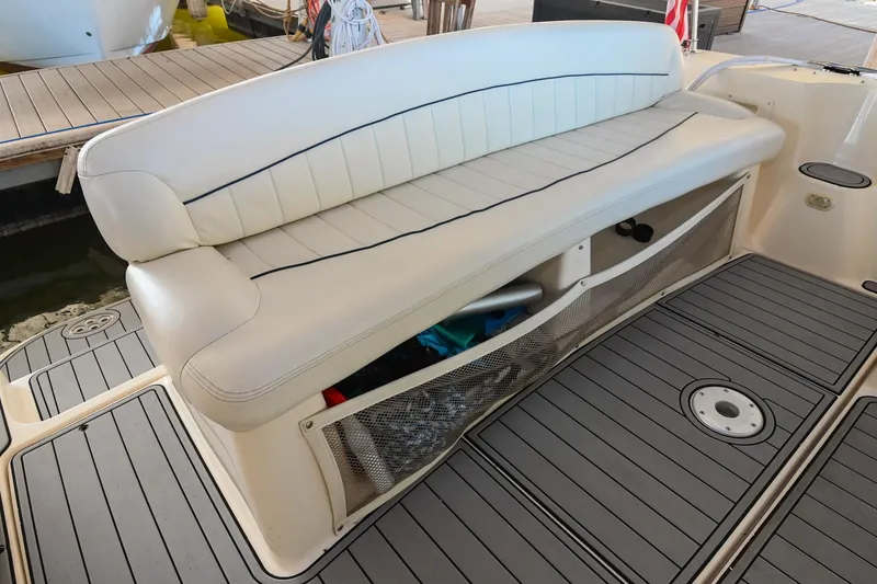 Slide: The Image of 2000 Rinker Fiesta Vee 330 boat seating area with storage compartment. - 9