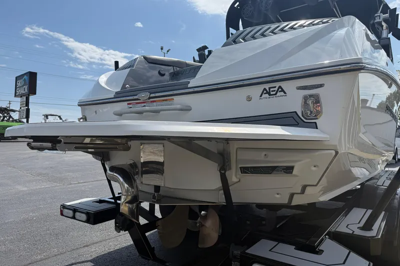 Slide: The Image of 2018 Nautique Super Air Nautique G23 boat rear view at dealership. - 10