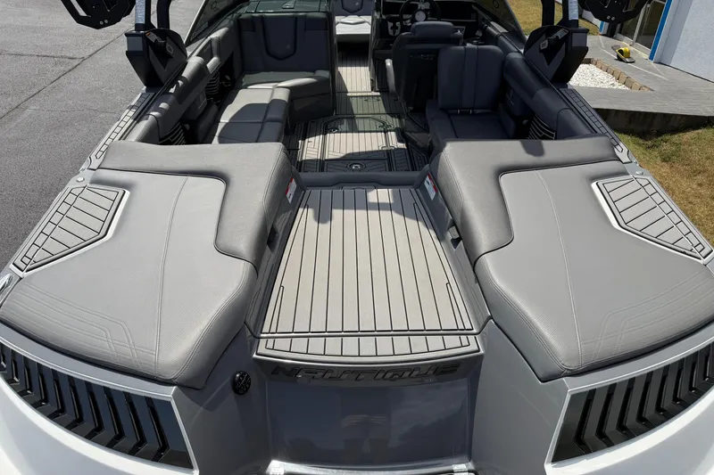 Slide: The Image of 2018 Nautique Super Air Nautique G23 boat interior with gray seating and deck. - 12