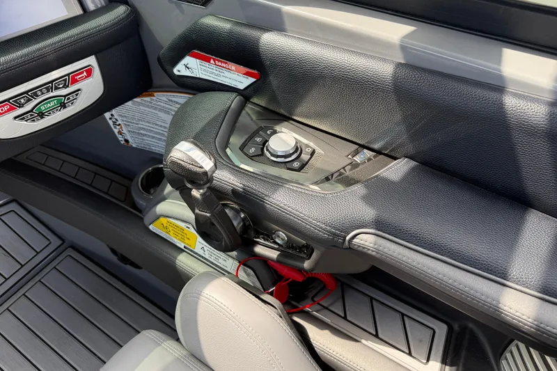 Slide: The Image of 2018 Nautique Super Air Nautique G23 boat control panel with start and stop buttons. - 17