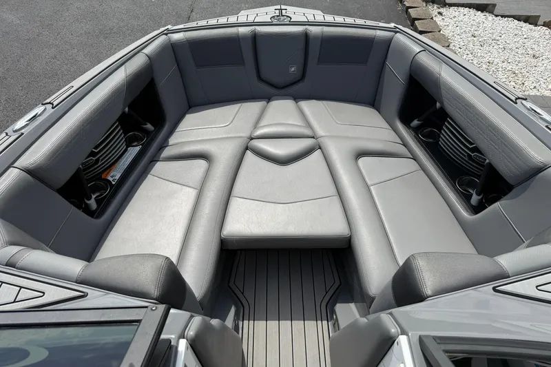 Slide: The Image of 2018 Nautique Super Air Nautique G23 boat interior with gray seating and cup holders. - 19