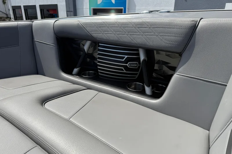 Slide: The Image of 2018 Nautique Super Air Nautique G23 interior with JL Audio speaker and cup holders. - 20