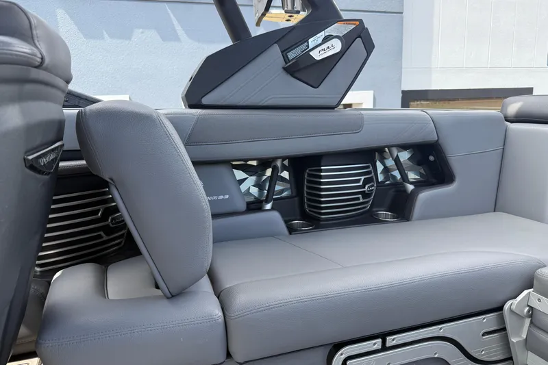 Slide: The Image of 2018 Nautique Super Air Nautique G23 interior with gray seating and audio system. - 24