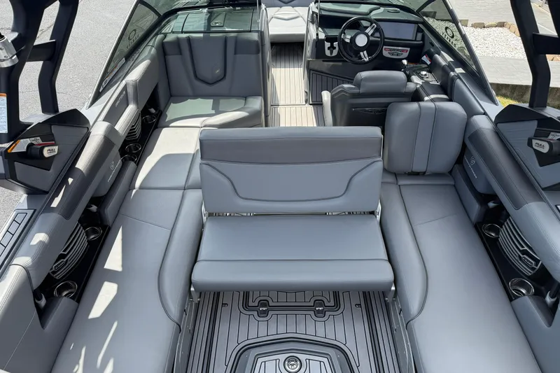 Slide: The Image of 2018 Nautique Super Air Nautique G23 interior with gray seating and modern dashboard. - 27