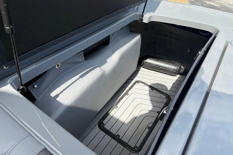 Slide: The Image of 2018 Nautique Super Air Nautique G23 storage compartment with open lid and interior view. - 32