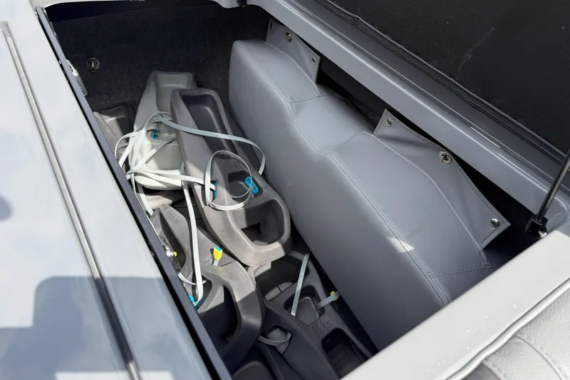 Slide: The Image of 2018 Nautique Super Air Nautique G23 storage compartment with gray interior and equipment. - 33