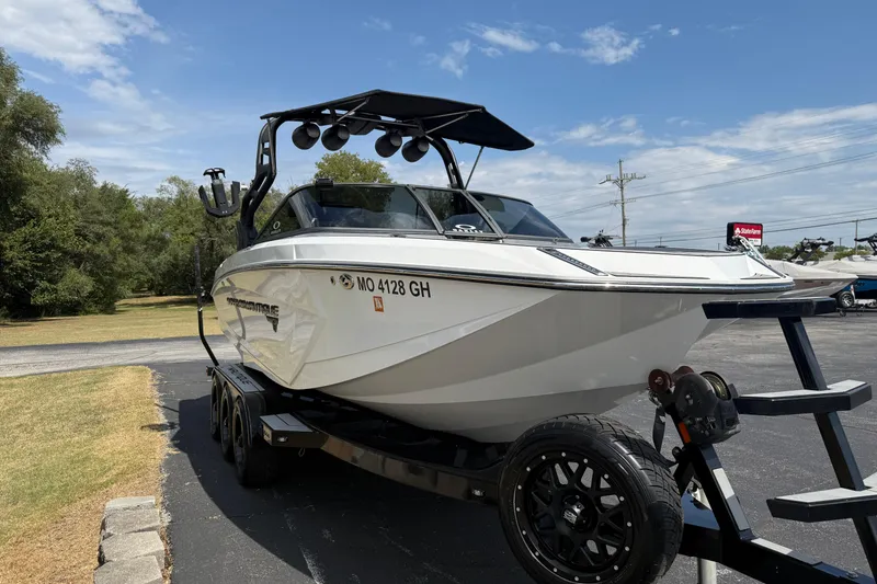 Slide: The Image of 2018 Nautique Super Air Nautique G23 boat on trailer, parked outdoors. - 4