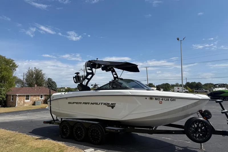 Slide: The Image of 2018 Nautique Super Air Nautique G23 boat on trailer under clear blue sky. - 5