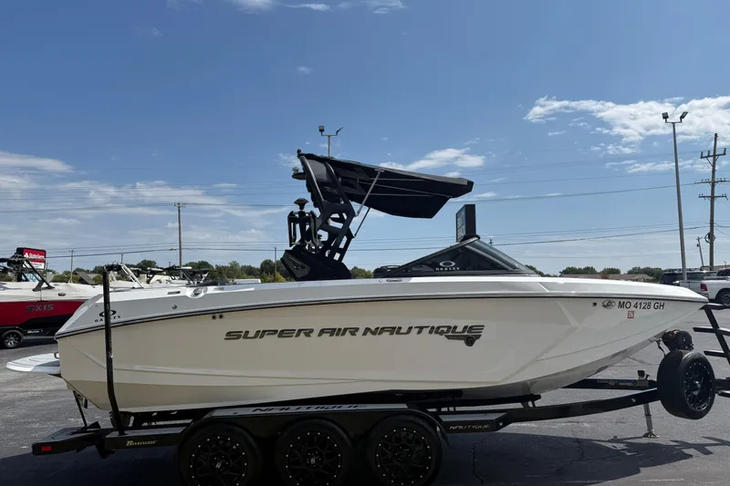 Slide: The Image of 2018 Nautique Super Air Nautique G23 boat on trailer under clear sky. - 6