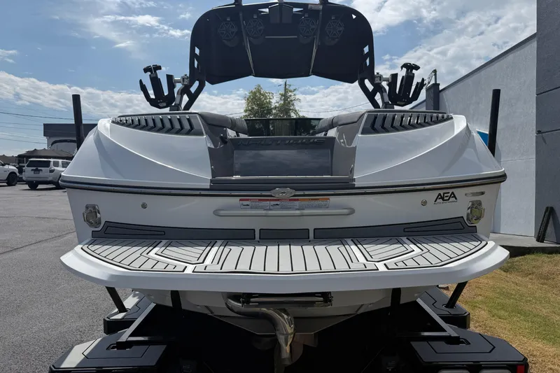 Slide: The Image of 2018 Nautique Super Air Nautique G23 boat, rear view, parked outdoors. - 8
